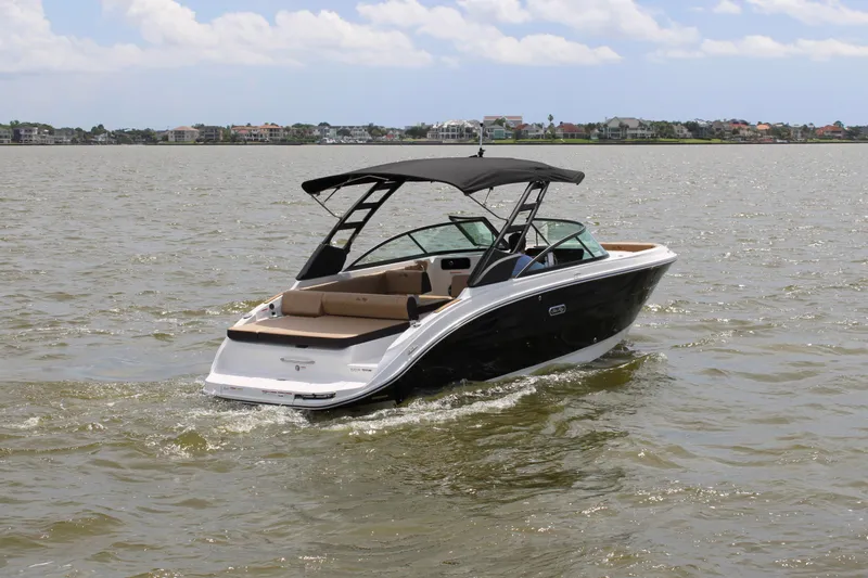 Slide: The Image of 2026 Sea Ray SDX 250 Surf on calm water, featuring a sleek design and black hull. - 3