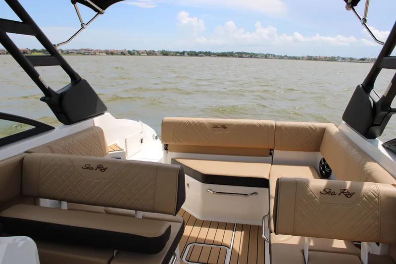 Slide: The Image of The image shows the interior of a 2026 Sea Ray SDX 250 Surf boat with beige seating. - 29