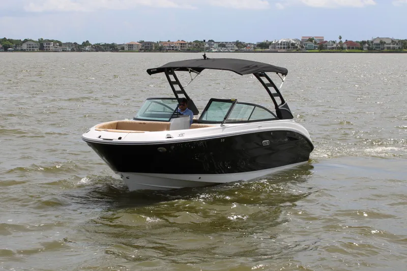 Slide: The Image of 2026 Sea Ray SDX 250 Surf on calm water, featuring a black hull and sunshade. - 7