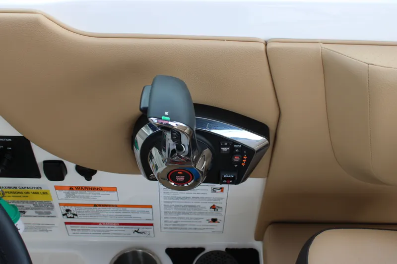 Slide: The Image of Close-up of the throttle control on a Sea Ray SDX 250 Surf boat, surrounded by warning labels. - 27