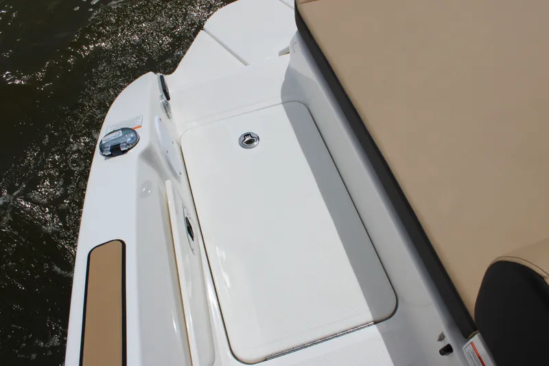 Slide: The Image of The image shows the deck of a 2026 Sea Ray SDX 250 Surf boat with beige upholstery. - 35