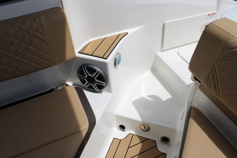 Slide: The Image of The image shows the interior of a 2026 Sea Ray SDX 250 Surf with beige upholstery and speakers. - 37