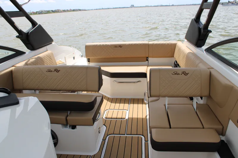 Slide: The Image of The image shows the interior of a 2026 Sea Ray SDX 250 Surf boat with beige upholstery. - 22