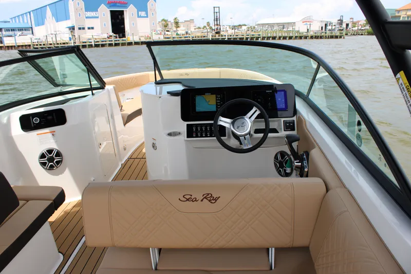 Slide: The Image of The image shows the cockpit of a 2026 Sea Ray SDX 250 Surf with modern steering and electronics. - 12