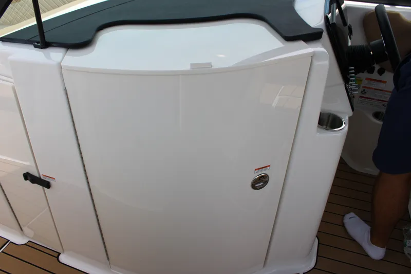 Slide: The Image of Interior view of the 2026 Sea Ray SDX 250 Surf with white cabinet and steering wheel. - 15