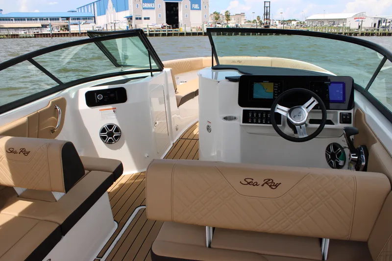 Slide: The Image of 2026 Sea Ray SDX 250 Surf: Luxurious interior with beige upholstery and modern cockpit. - 13