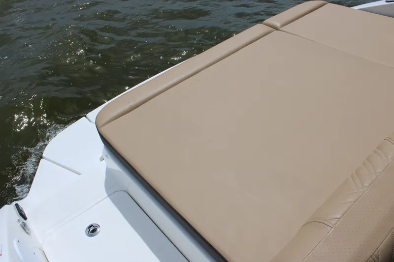Slide: The Image of The image shows the sun deck of a 2026 Sea Ray SDX 250 Surf on the water. - 36