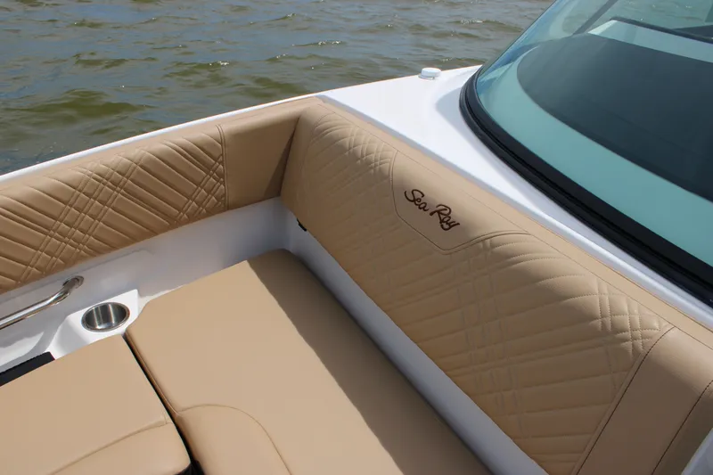Slide: The Image of 2026 Sea Ray SDX 250 Surf with beige quilted upholstery and embroidered logo. - 20
