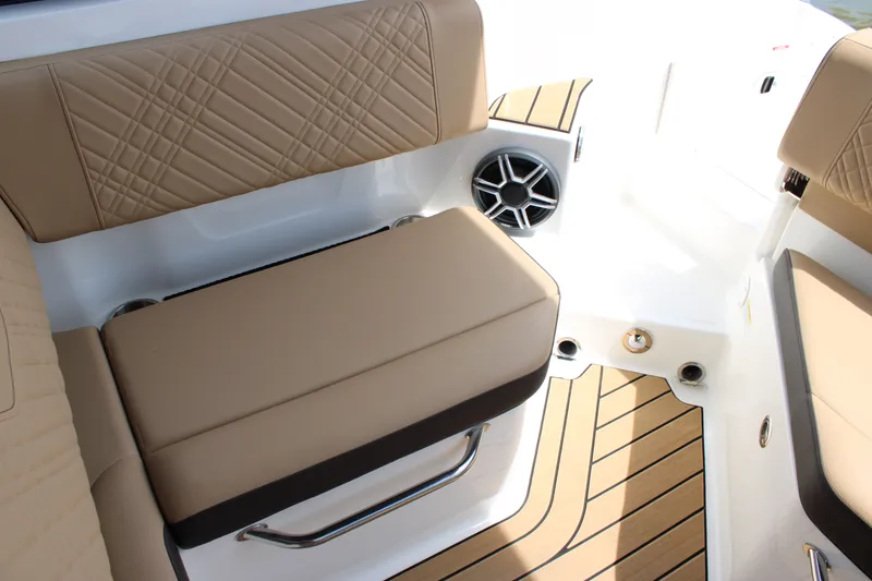 Slide: The Image of The 2026 Sea Ray SDX 250 Surf features an elegant bench seat with quilted upholstery and a speaker. - 34