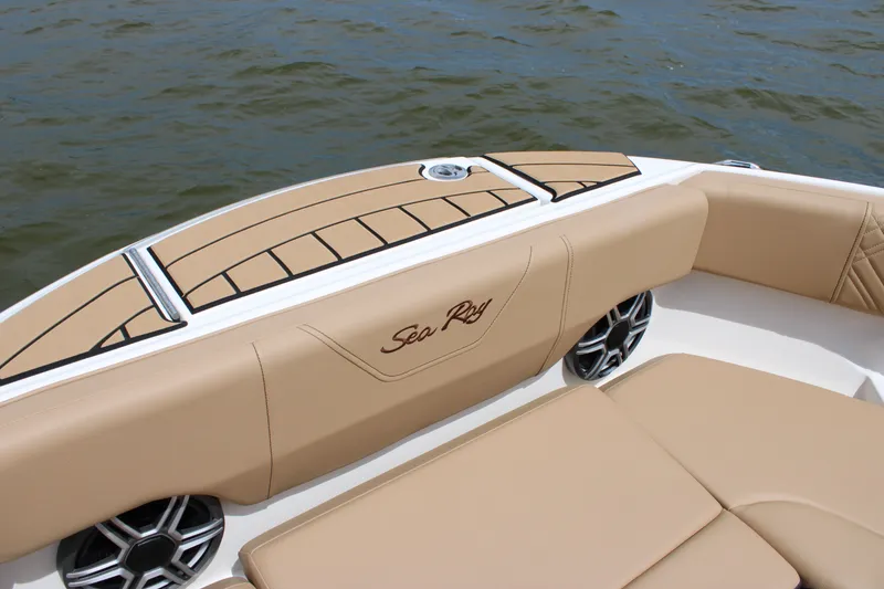 Slide: The Image of The image shows the elegant beige interior of a Sea Ray SDX 250 Surf boat on the water. - 21