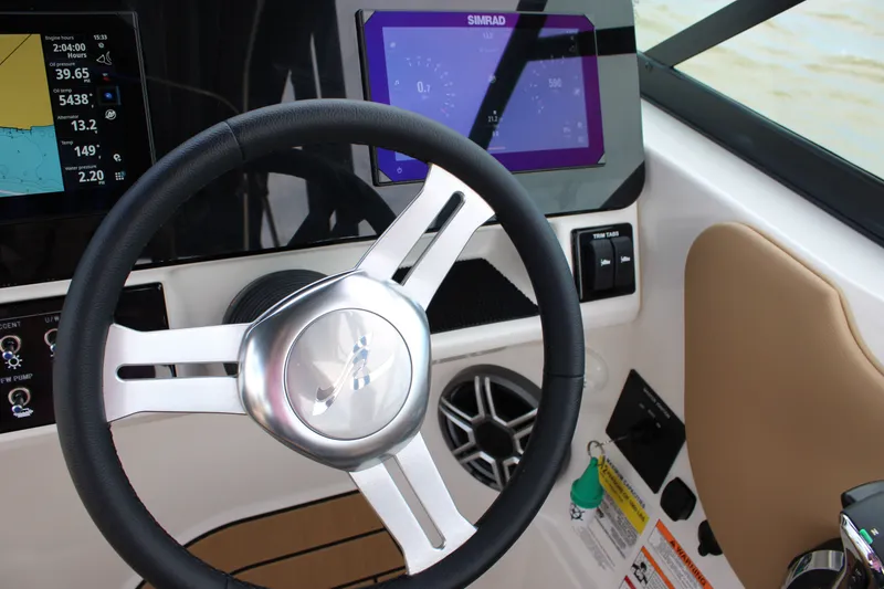 Slide: The Image of Helm of the Sea Ray SDX 250 Surf with modern instruments and a sleek steering wheel. - 25