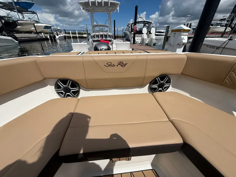 Slide: The Image of The image shows the seating area of a Sea Ray SDX 230 Outboard with beige upholstery. - 7
