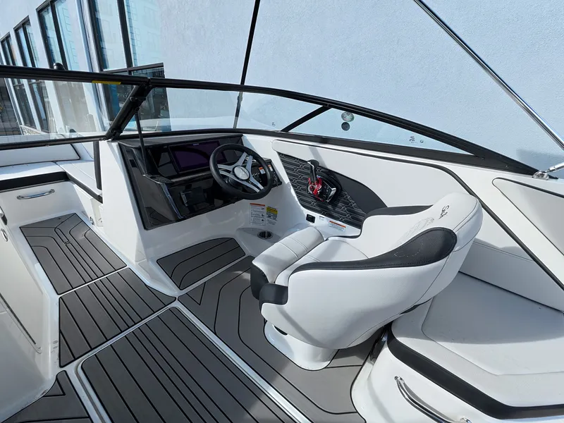 Slide: The Image of The image shows the cockpit of a Sea Ray SPX 210 Outboard with modern steering wheel and seating. - 21
