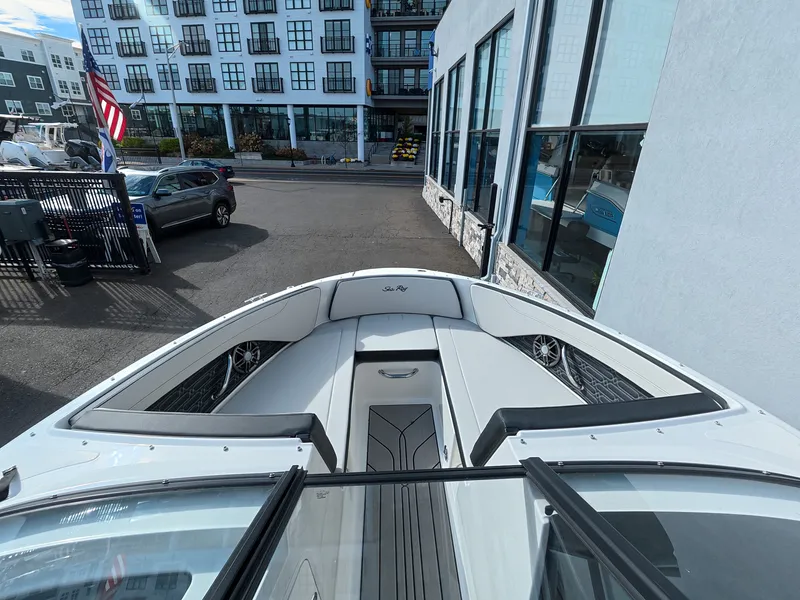 Slide: The Image of The image shows the bow of a Sea Ray SPX 210 Outboard boat in an urban marina. - 29