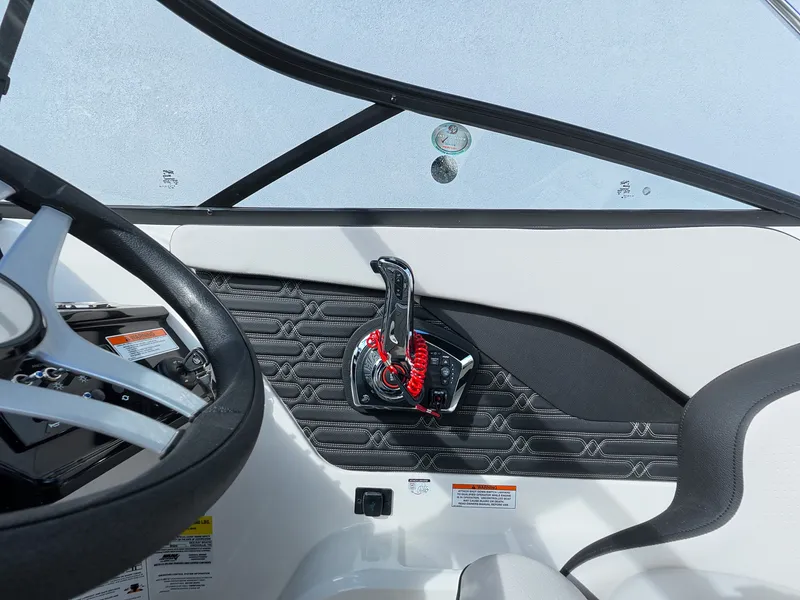 Slide: The Image of The image shows the cockpit of a Sea Ray SPX 210 Outboard with a modern throttle lever. - 28