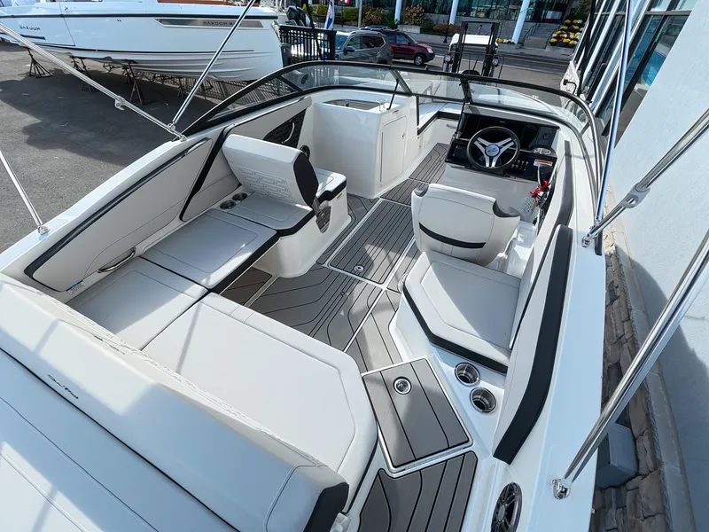 Slide: The Image of The image shows the interior of a Sea Ray SPX 210 Outboard boat with modern seating and controls. - 14