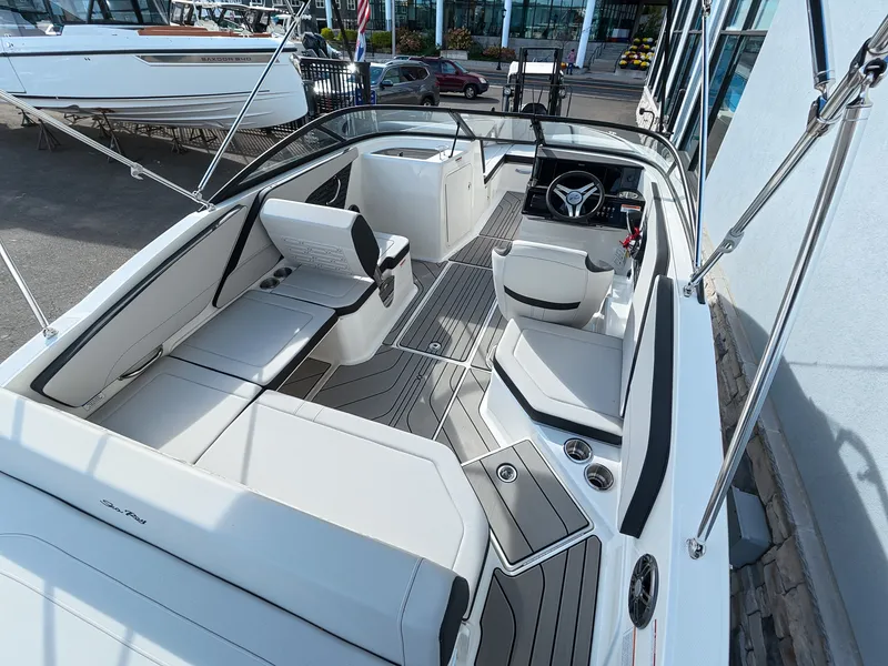 Slide: The Image of The image shows the cockpit of a Sea Ray SPX 210 Outboard boat with modern seating and controls. - 15