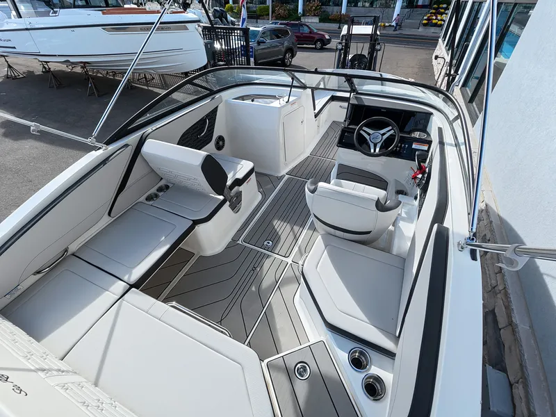 Slide: The Image of The image shows the cockpit of a Sea Ray SPX 210 Outboard boat with modern seating and controls. - 17