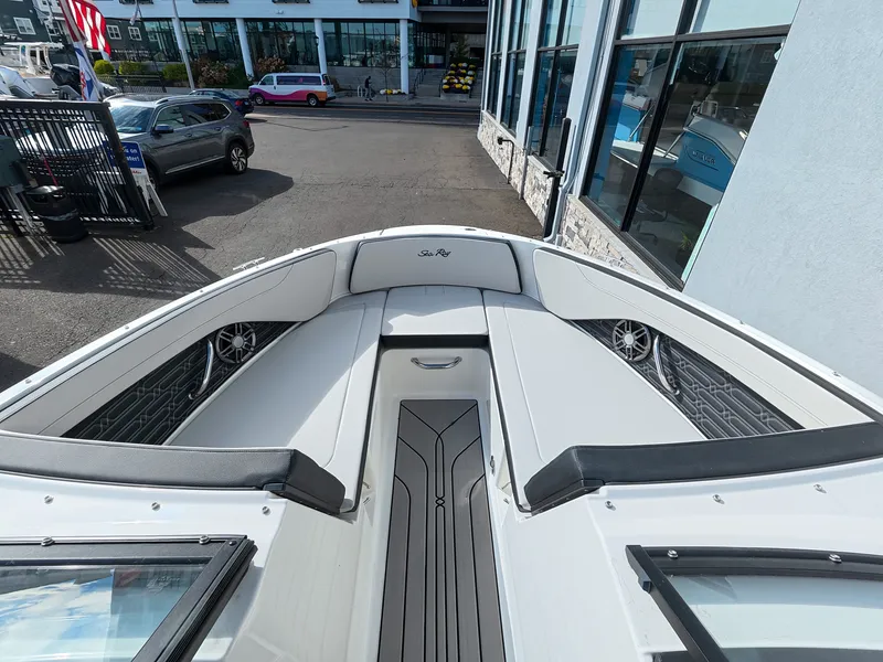 Slide: The Image of The image shows the bow of a Sea Ray SPX 210 Outboard with sleek seating and speakers. - 30