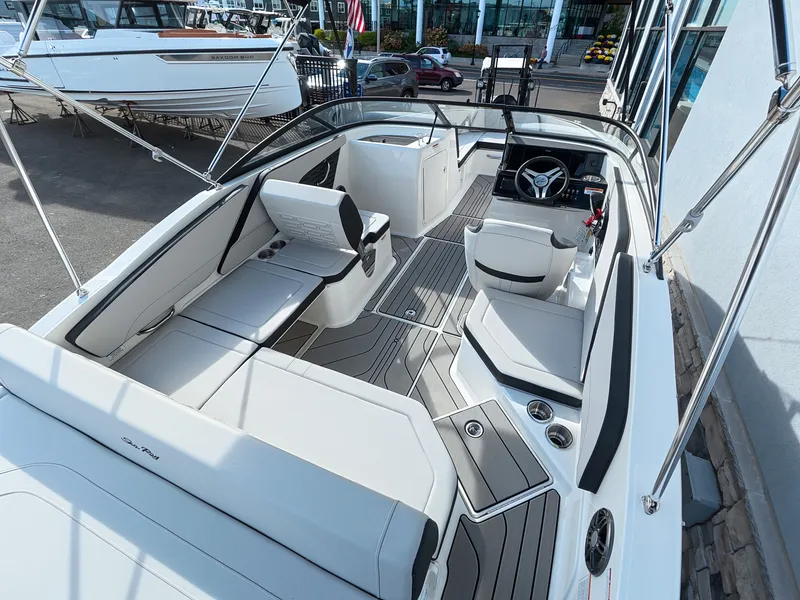 Slide: The Image of The image shows the cockpit of a Sea Ray SPX 210 Outboard boat with modern seating and controls. - 16