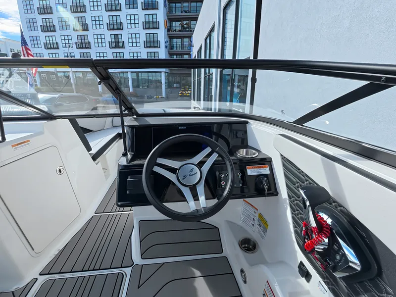 Slide: The Image of The cockpit of a Sea Ray SPX 210 Outboard with a modern steering wheel and instruments. - 24