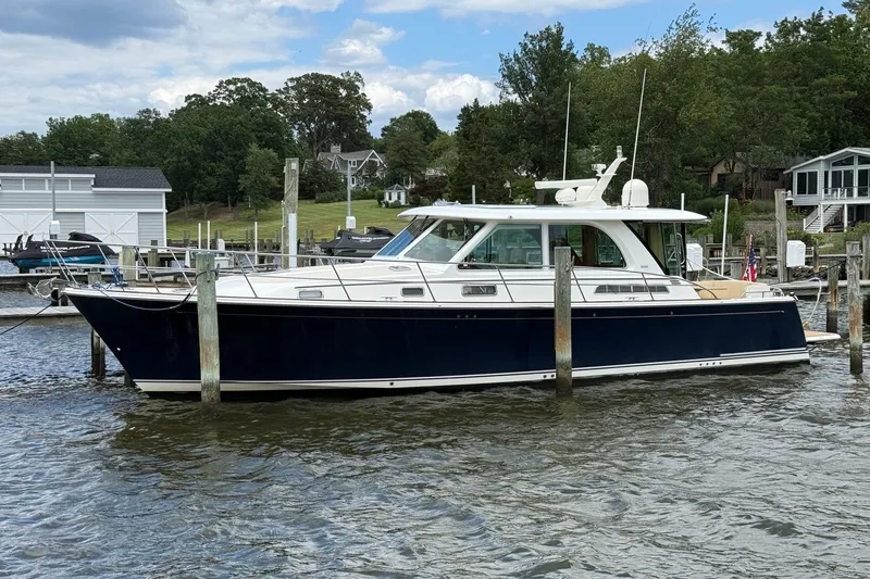 The Image of 2019 Sabre 45 Salon Express yacht docked in a scenic marina setting. - 0