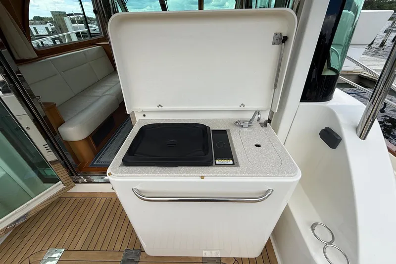 Slide: The Image of Outdoor kitchenette on 2019 Sabre 45 Salon Express yacht, featuring sink and grill. - 11