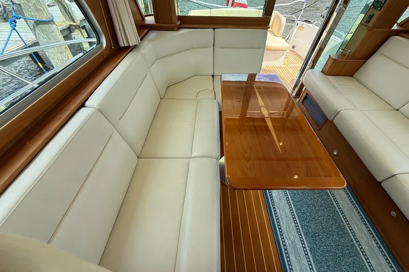 Slide: The Image of Luxurious interior of 2019 Sabre 45 Salon Express with elegant seating and wooden table. - 16