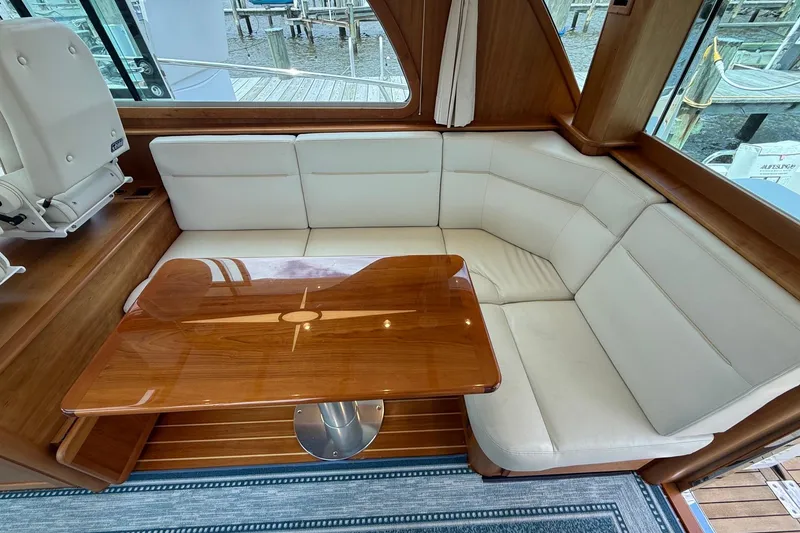 Slide: The Image of Luxurious interior of 2019 Sabre 45 Salon Express with elegant wood table and white seating. - 18