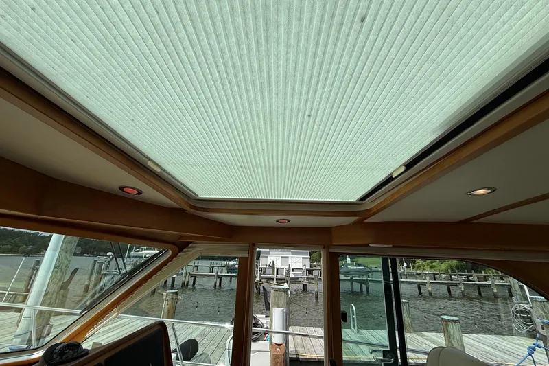 Slide: The Image of Interior view of 2019 Sabre 45 Salon Express yacht with skylight and dockside scenery. - 19