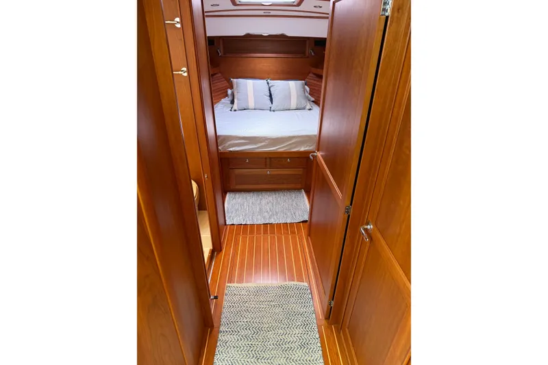 Slide: The Image of 2019 Sabre 45 Salon Express cabin interior with wooden finish and cozy bed. - 29