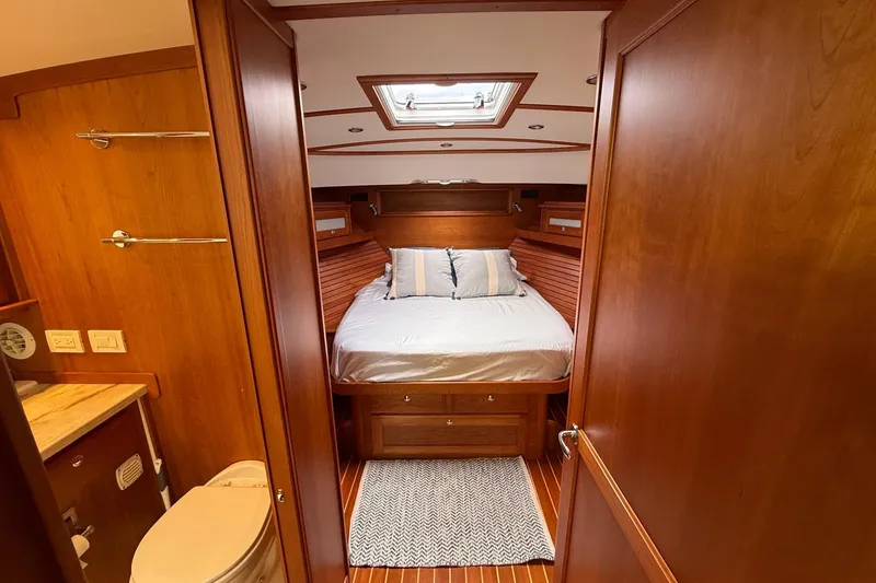 Slide: The Image of Luxurious 2019 Sabre 45 Salon Express cabin interior with bed and wooden finish. - 30