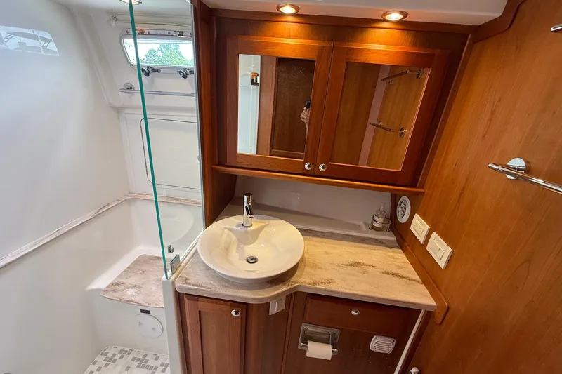 Slide: The Image of Luxurious bathroom in 2019 Sabre 45 Salon Express yacht with wood cabinetry and modern fixtures. - 32