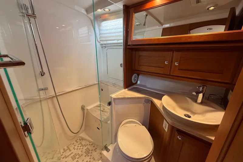 Slide: The Image of Luxurious bathroom in 2019 Sabre 45 Salon Express yacht with modern fixtures and wooden cabinetry. - 33