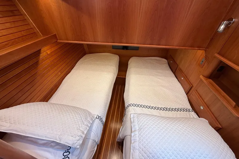 Slide: The Image of Twin beds in the 2019 Sabre 45 Salon Express cabin with wooden interior. - 34