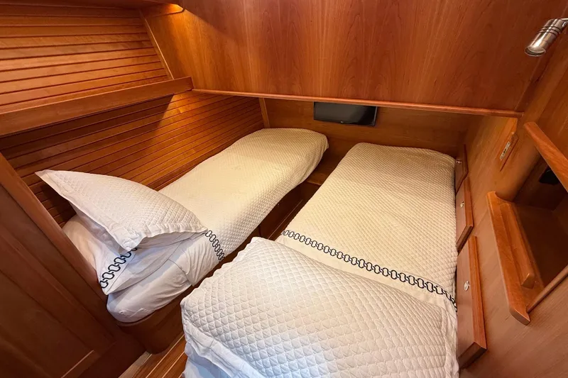 Slide: The Image of 2019 Sabre 45 Salon Express cabin with twin beds and wooden interior. - 35