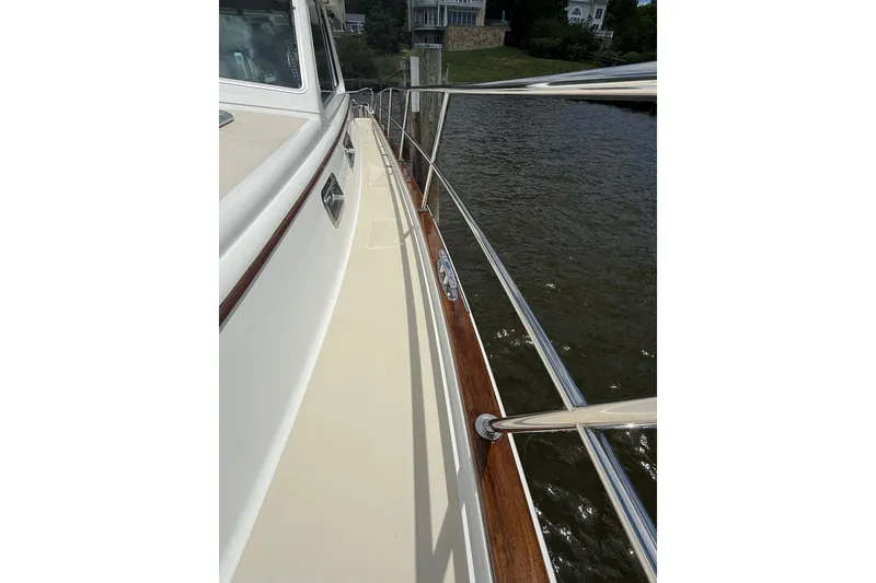 Slide: The Image of 2019 Sabre 45 Salon Express yacht deck with polished railings and water view. - 4