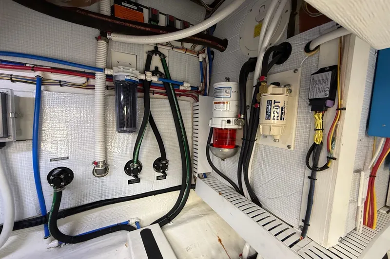 Slide: The Image of Engine room of 2019 Sabre 45 Salon Express with various mechanical components and wiring. - 41