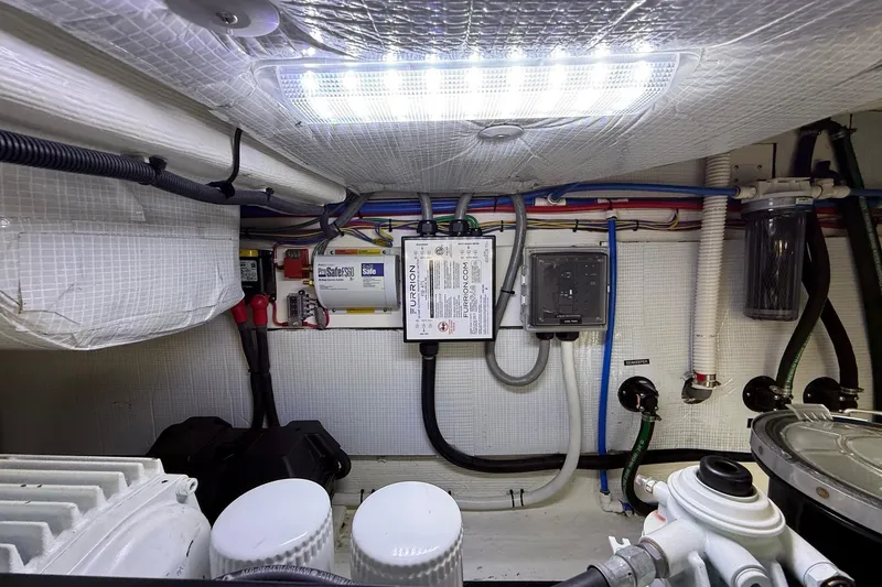 Slide: The Image of Engine room of 2019 Sabre 45 Salon Express with electrical and plumbing systems. - 42
