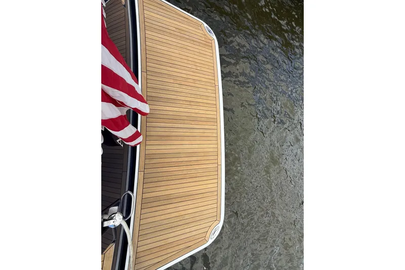 Slide: The Image of 2019 Sabre 45 Salon Express boat deck with American flag, overlooking water. - 48