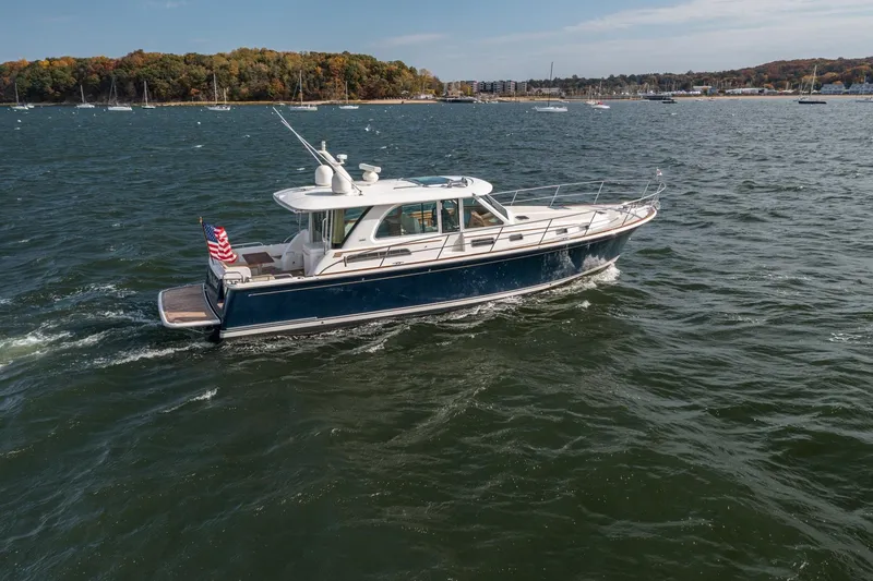 Slide: The Image of 2019 Sabre 45 Salon Express cruising on a scenic lake with autumn foliage. - 50