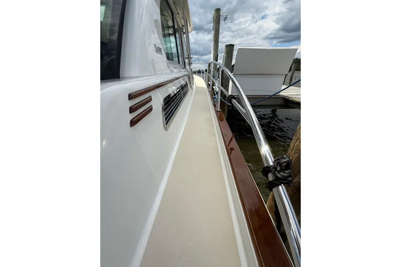 Slide: The Image of 2019 Sabre 45 Salon Express yacht deck with polished railings and dock view. - 7