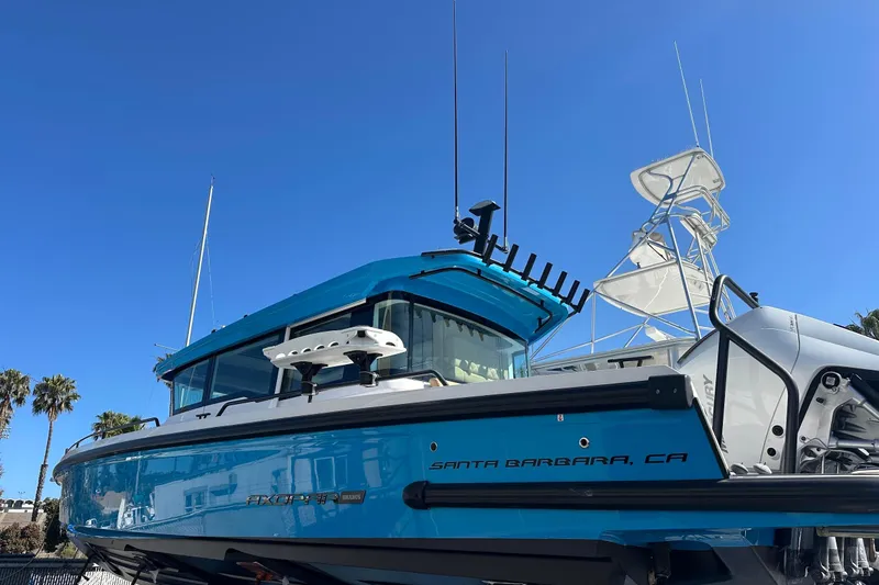 Slide: The Image of 2021 Axopar 37 XC Cross Cabin boat in Santa Barbara, CA, under clear blue sky. - 1