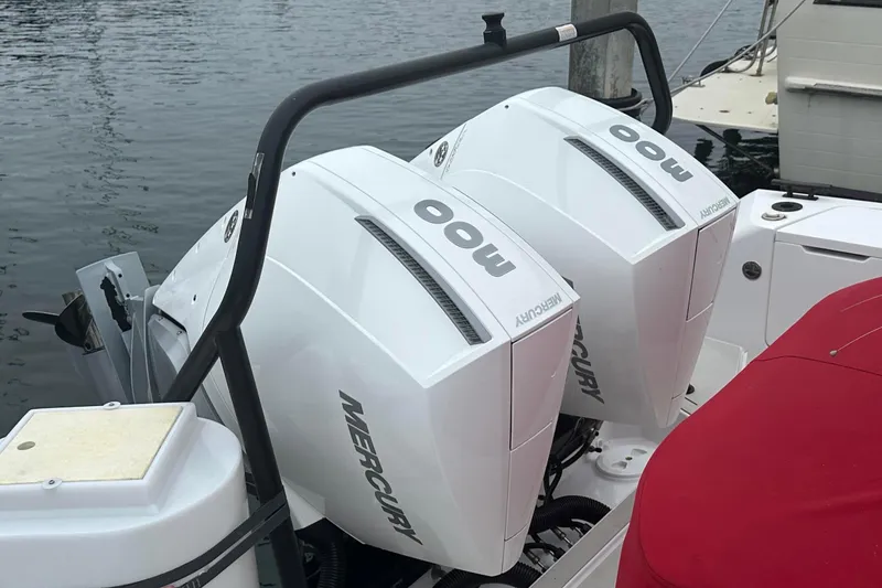 Slide: The Image of Twin Mercury outboard engines on a 2023 Axopar Brabus boat, docked by the water. - 15