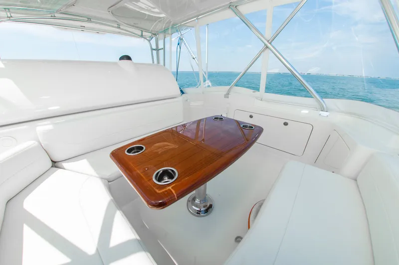 Slide: The Image of Interior of a 2008 Bertram 510 Convertible yacht with wooden table. - 14