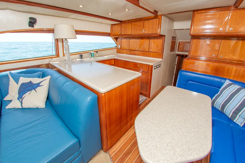 Slide: The Image of Interior of a 2008 Bertram 510 Convertible yacht with blue sofas. - 22