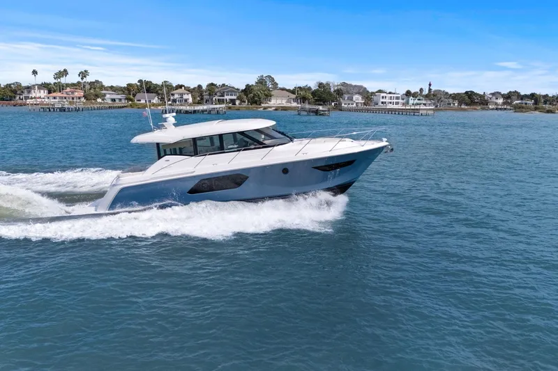 The Image of 2023 Tiara Yachts C49 Coupe cruising on a scenic waterway. - 0