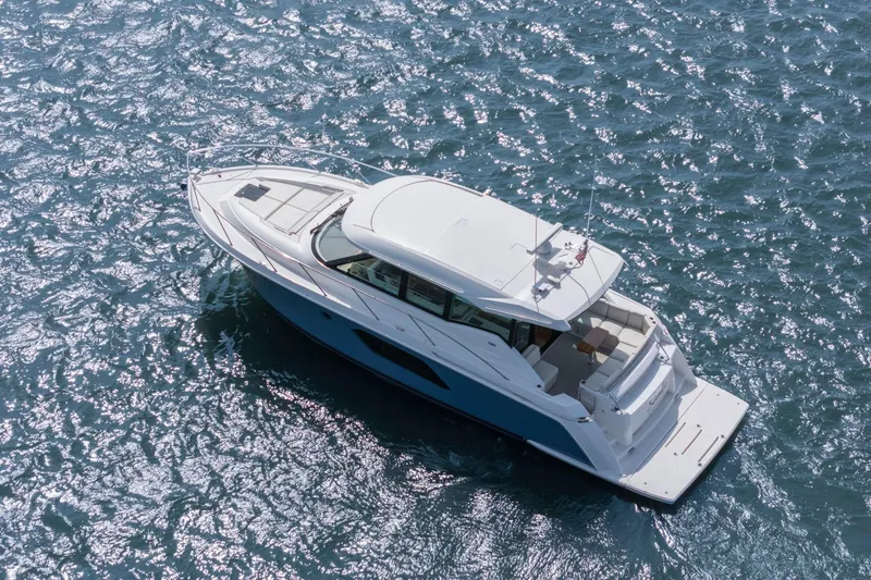 Slide: The Image of 2023 Tiara Yachts C49 Coupe cruising on sparkling blue water. - 10