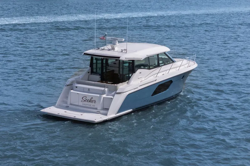Slide: The Image of 2023 Tiara Yachts C49 Coupe cruising on open water. - 11
