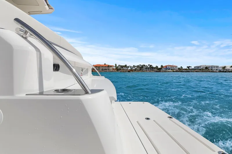 Slide: The Image of 2023 Tiara Yachts C49 Coupe on blue water with coastal view. - 12